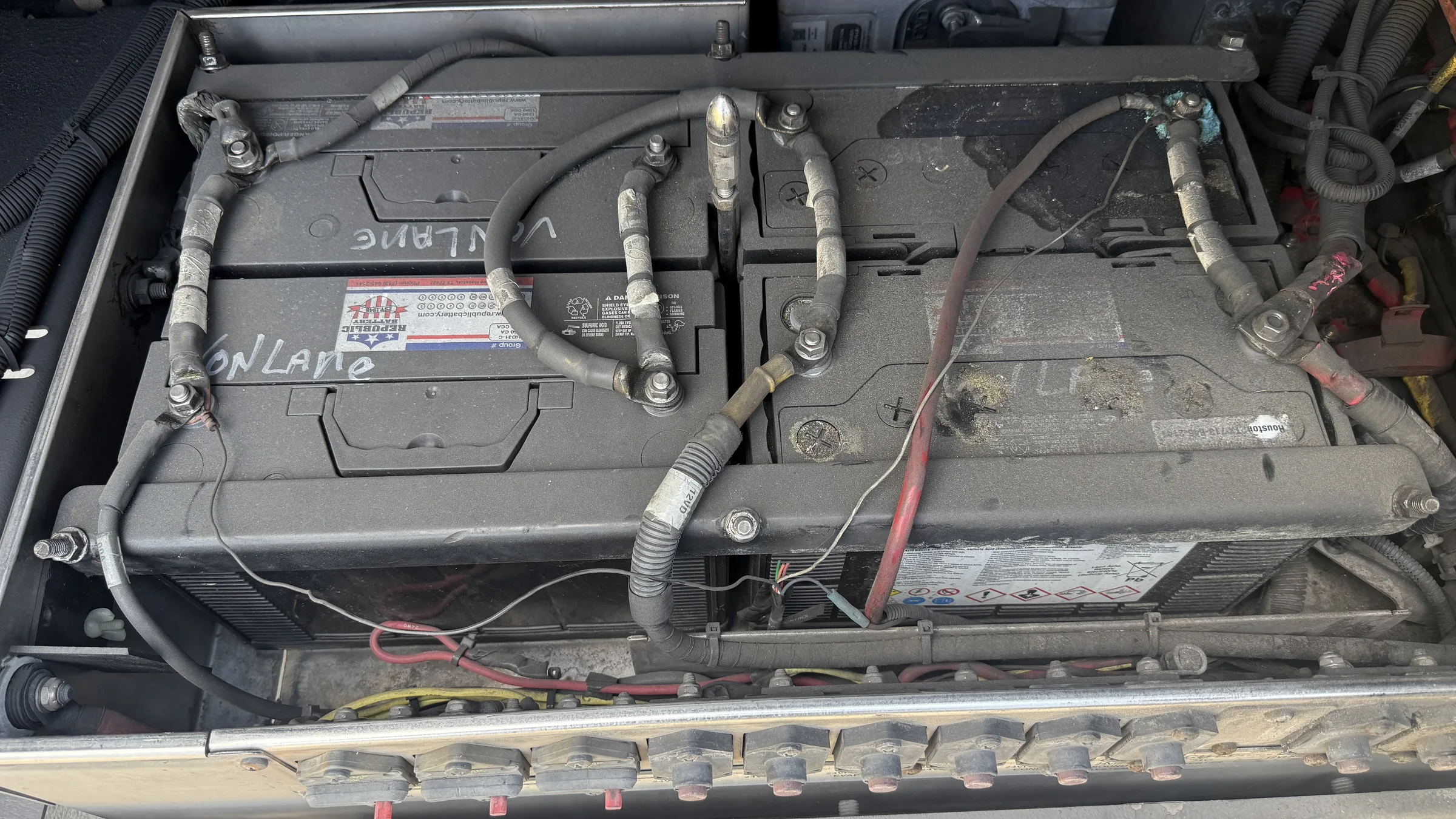 Battery box open showing 12V batteries cabled together