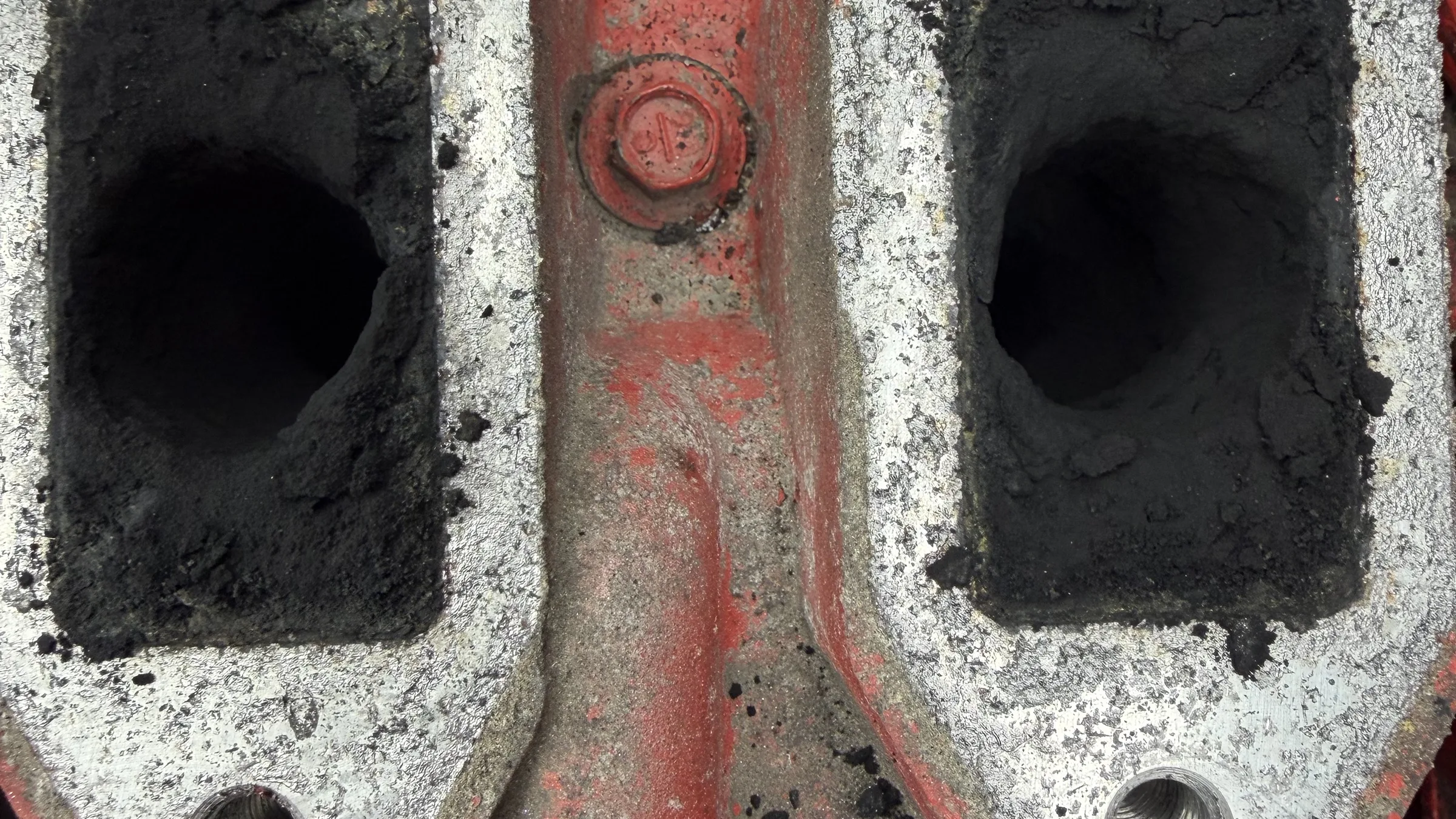 Cylinder-head exhaust ports caked with carbon buildup