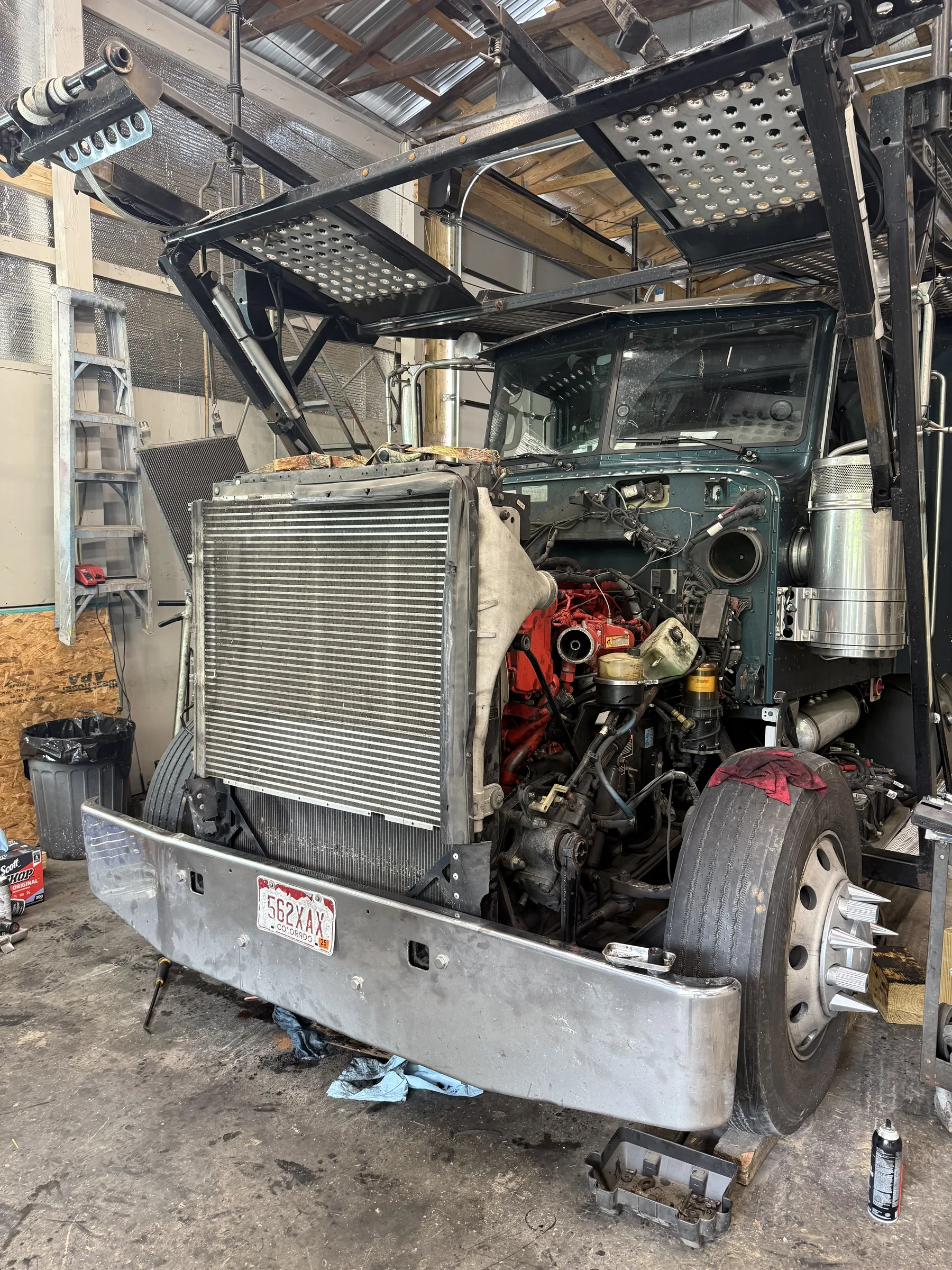 Cabover truck with the cab tilted forward for service access