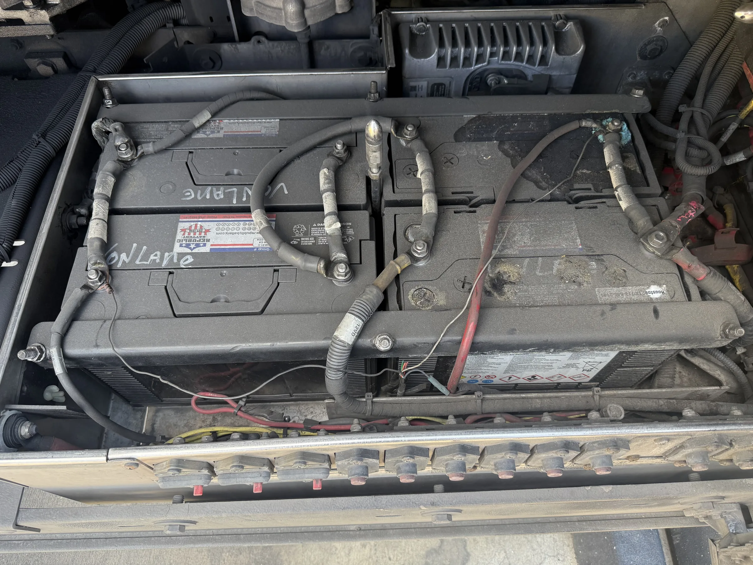 Battery box open showing 12V batteries cabled together