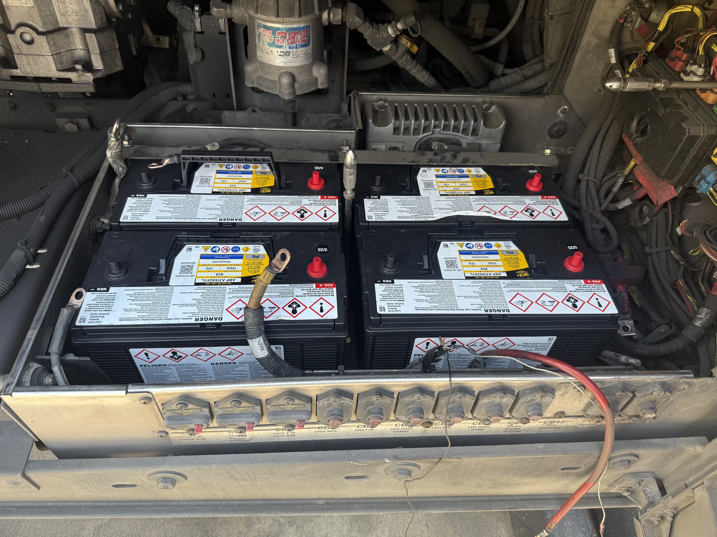 Bank of four 12V batteries installed in a battery box