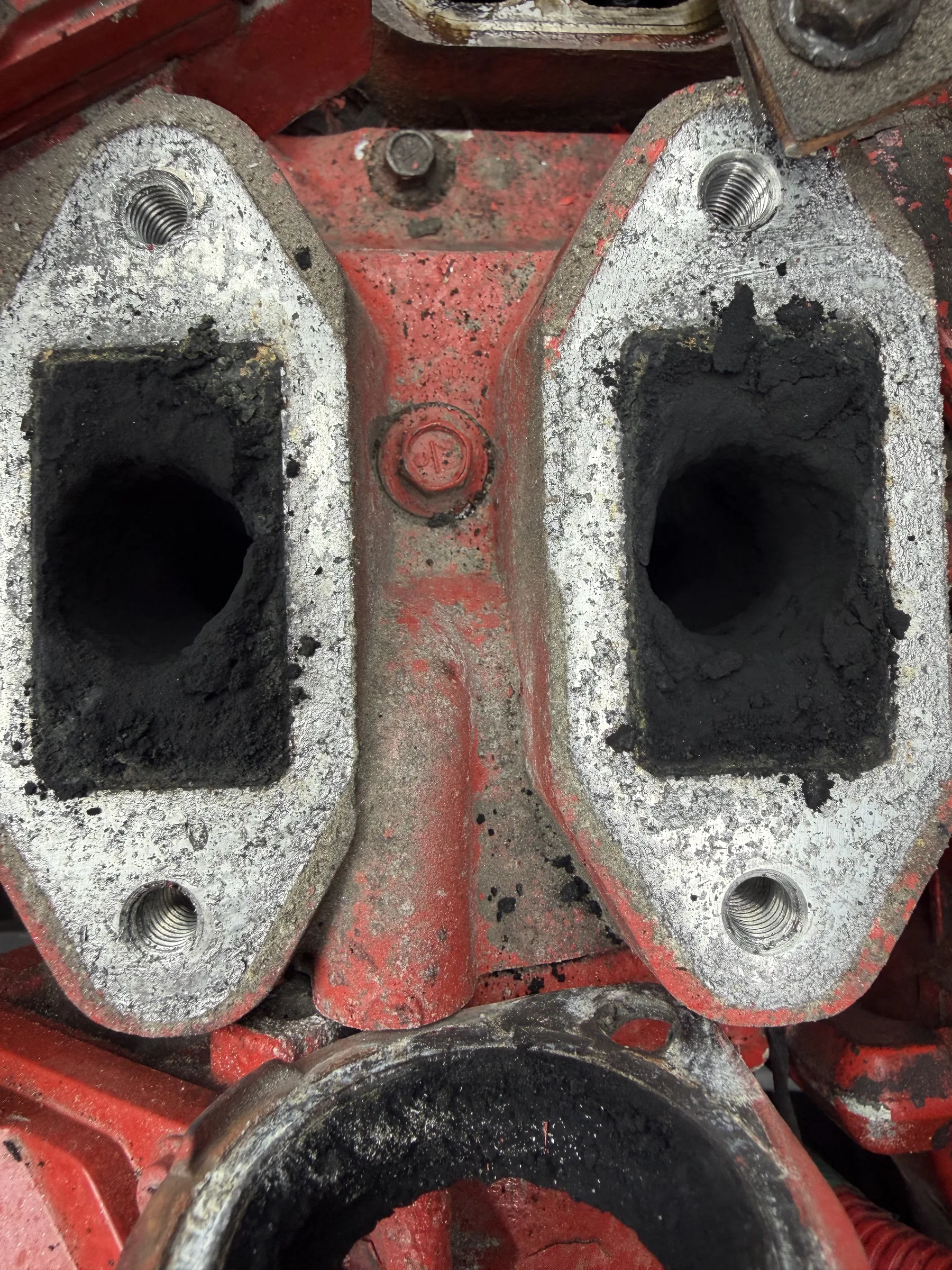 Cylinder-head exhaust ports caked with carbon buildup