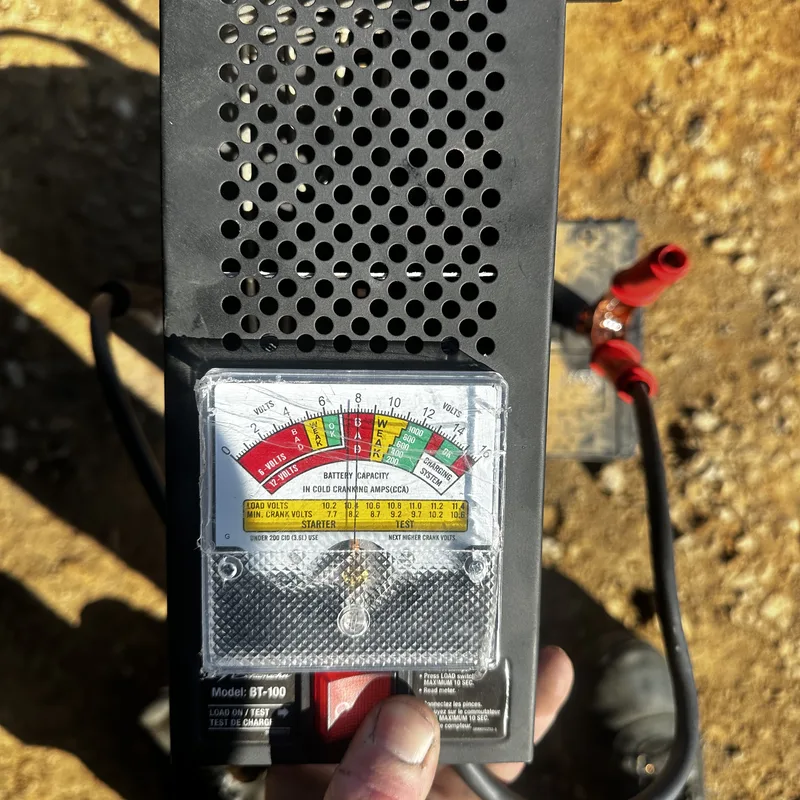 Carbon-pile battery load tester reading a customer battery
