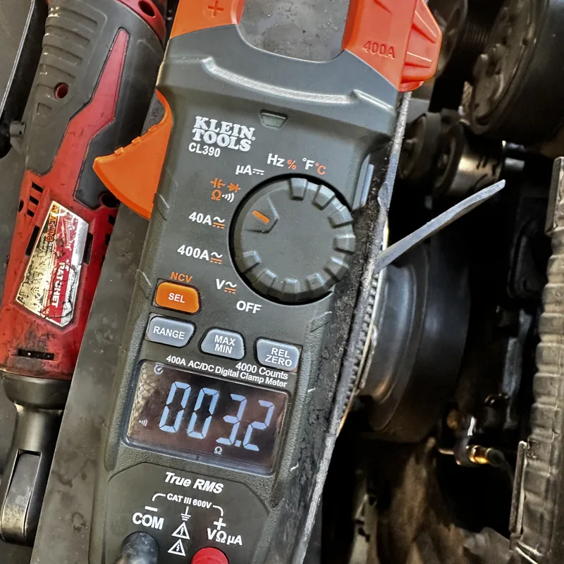 Clamp meter clamped on a wire during electrical diagnosis