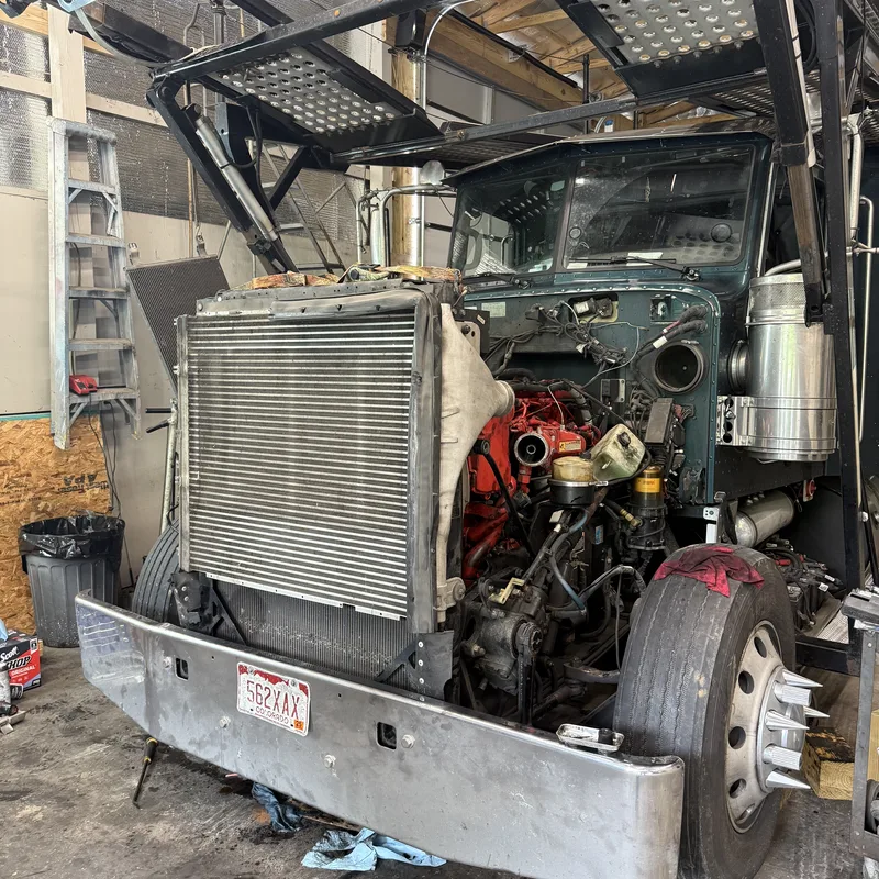 Cabover truck with the cab tilted forward for service access