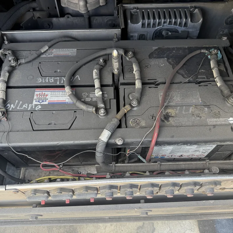Battery box open showing 12V batteries cabled together