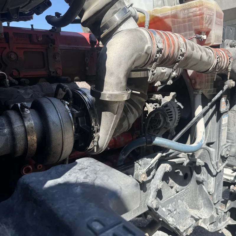 Engine bay with intake plumbing and alternator visible