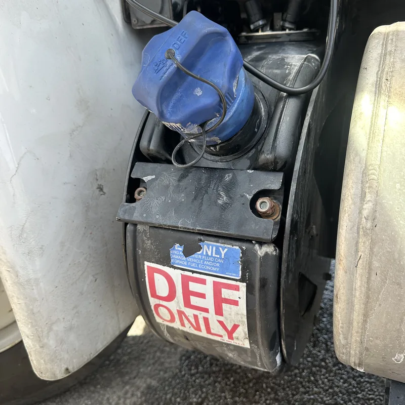 DEF fill door open at the side of a heavy-duty truck